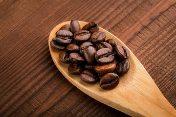 Coffee beans and cinnamon on a background of burlap. Roasted coffee beans background close up. Coffee beans pile from top with copy space for text. Seasoning. Spice. Cinnamon. Badian. Coffee house.