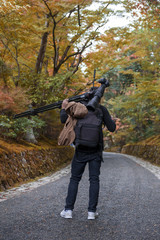 Fototapeta premium Photographer in Japanese garden in Kyoto during autumn