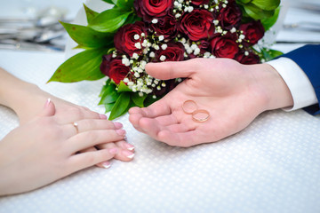 Fototapeta premium Wedding rings in the palm of the groom