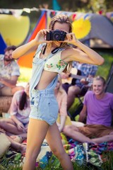Obraz na płótnie Canvas Woman taking a picture at campsite