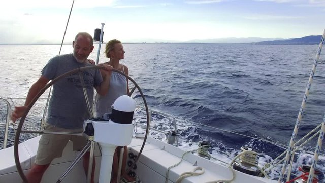 couple on sailboat sailing the ocean