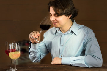 Enologist tasting wine at winery, with three glasses