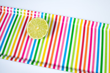 A lime sliced in half  on multicolored tray