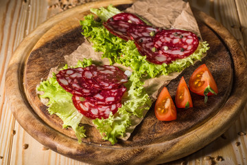 Sliced tasty Chorizo sausage over the wooden background
