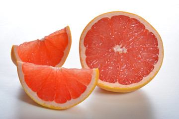 Fototapeta na wymiar Pink grapefruit slices on a white background