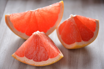 Pink grapefruit slices on a wooden board