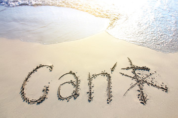 Can word written at the sand beach with sea wave water