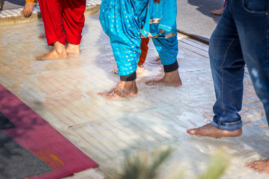 Cleaning the feet before entering the Golden Temple of Amritsar, India