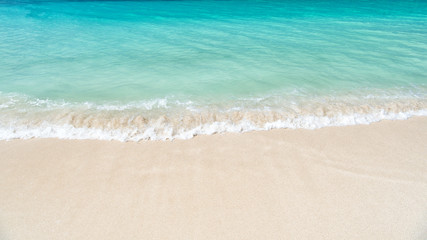 Fototapeta na wymiar wavy sea, ocean water background on sand coast in Antigua