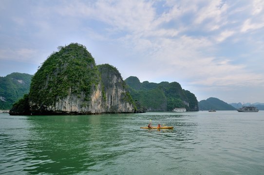 Vietnam, Halong bay. people who exploring the bay with a kayak in a beatiful summer day
