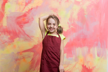 small girl chef with happy face in cook apron
