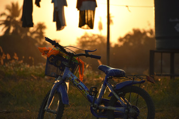 Naklejka na ściany i meble bicycle for kid with the sunset