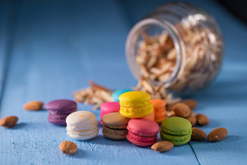 Colorful macarons on blue table background