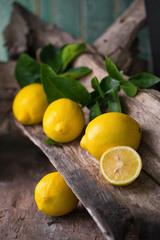 Fresh ripe lemons on Dark vintage wood texture background