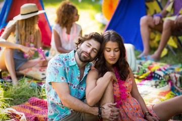 Couple sitting near campsite