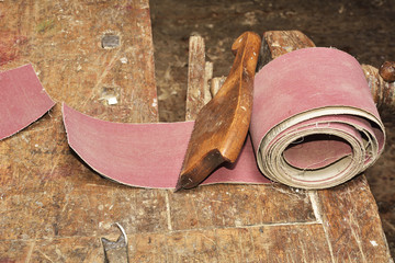 carpenter working with plane on wooden background