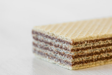 Closeup of a waffle with chocolate cream isolated on white background - selective focus, copy space
