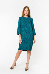 Young elegant female in light summer dress, over white background