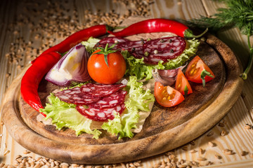 Sliced tasty Chorizo sausage over the wooden background
