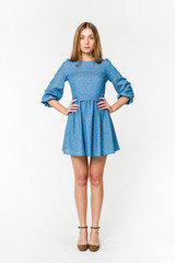 Young elegant female in light summer dress, over white background