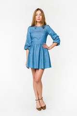 Young elegant female in light summer dress, over white background