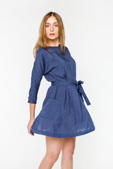 Young elegant female in light summer dress, over white background