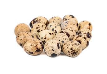 Many raw quail eggs on a white background