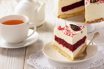 Homemade biscuit cake with cherry jelly and cream.