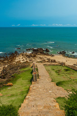 Narrow view of ruined stone staircase with seashore background from viewpoint,Kailashgiri,Visakhapatnam,Andhra Pradesh,March05 2017