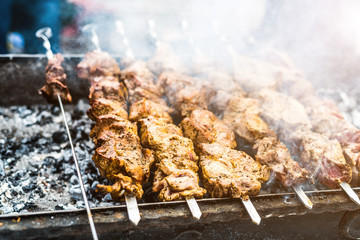 fleshy kebab roasting on mangal with smoke