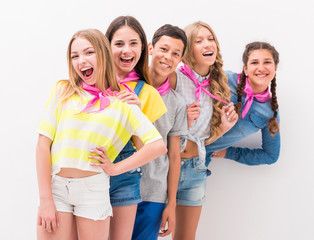 cute teenage children standing one by one holding each other