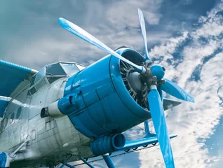 Peel and stick wall murals Old airplane plane with propeller on beautiful bright sky background