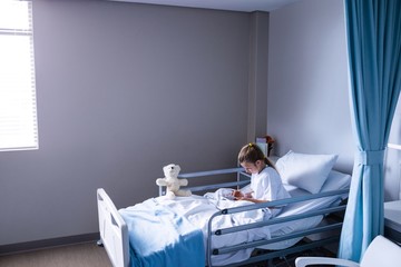 Patient using digital tablet in ward