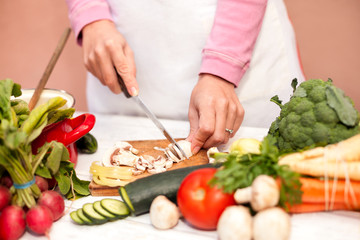 Cutting of fresh champignons in the kitchen