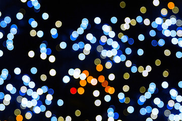 Lights blurred bokeh background from christmas night party for your design, vintage or retro color toned.