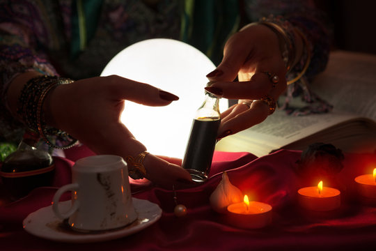 Hands of an fortune teller with holding love potion