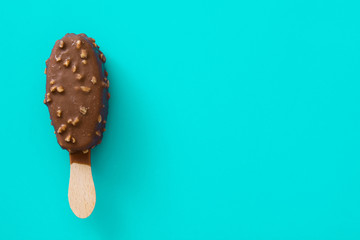 Black and white chocolate ice cream popsicles on blue background. 
