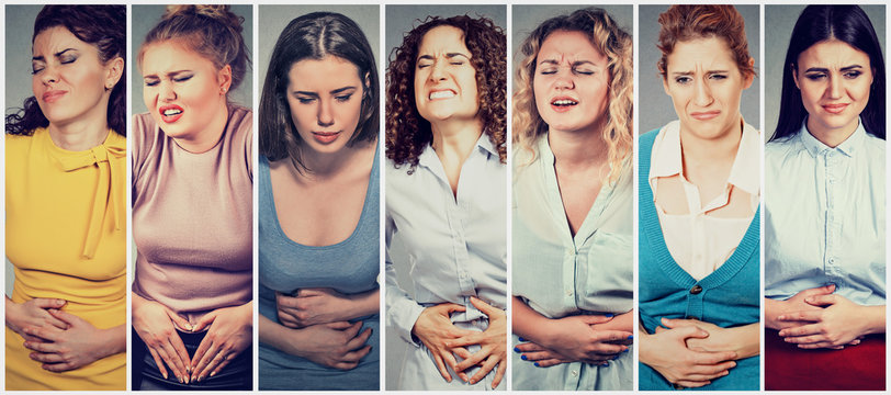 Group of young women with hands on stomach having bad aches pain