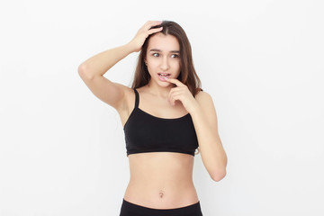 Beautiful girl in black top on white background shows emotion