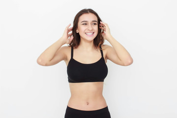 Beautiful girl in black top on white background shows emotion