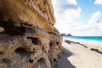 Rock & sand wall on the beach near the ocean. New Providence, Nassau, Bahamas.