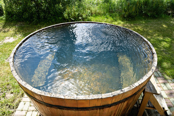 Wooden bathtub with cold water