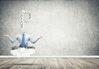 Headless meditating businessman