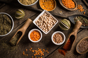 Various colorful spices on wooden table. Place for typography and logo