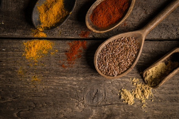 Various colorful spices on wooden table. Place for typography and logo