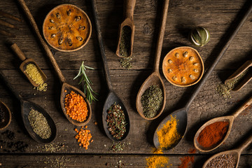 Various colorful spices on wooden table. Place for typography and logo