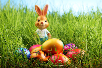 Sugar rabbit and easter eggs on meadow.