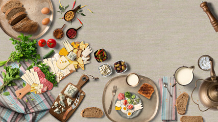 Overhead view of colorful roast vegetables, savory sauces and salt served with grilled t-bone steak on a rustic wooden counter in a country steakhouse