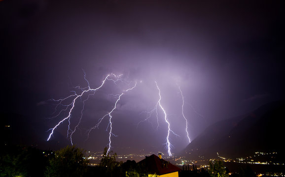 A strong thunderstorm discharge many lightning on the Meran city, during the night. Passiria Valley, Trentino Alto Adige, Italy
