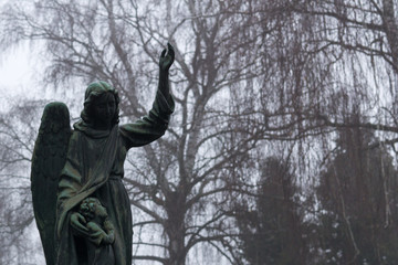 Statue of angel in cemetery during misty morning. Slovakia